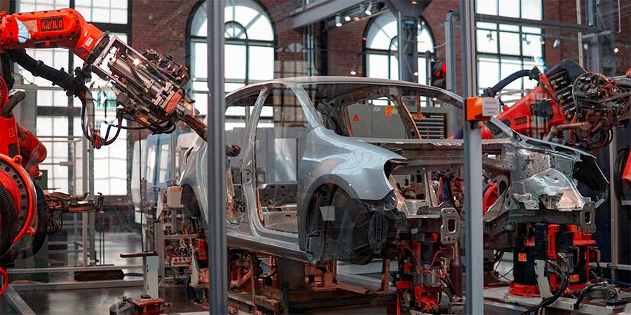 Car getting fixed by robotic engineer.